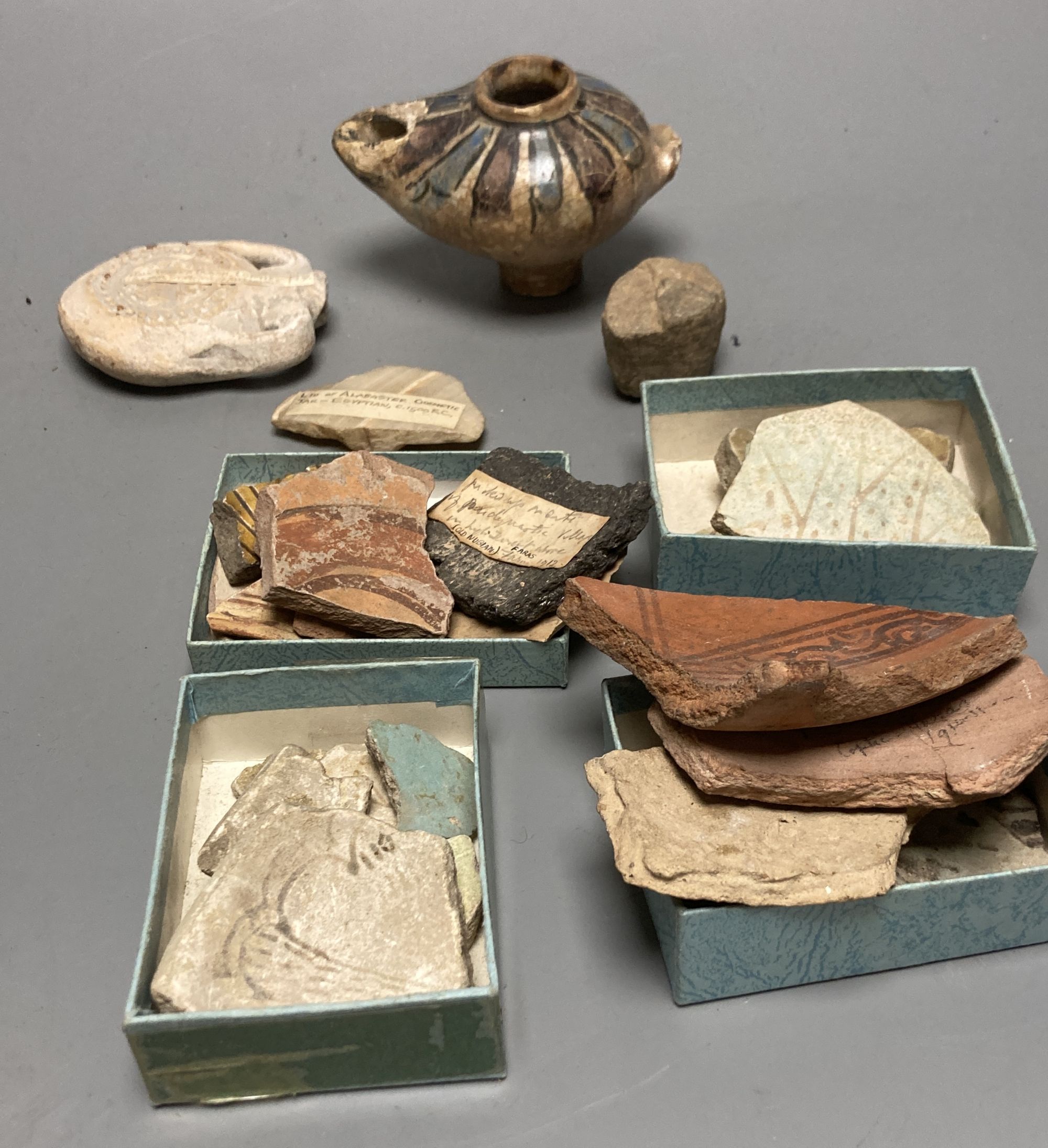 A group of Egyptian pottery fragments, Coptic period, together with a Syrian Islamic pottery oil lamp fragment